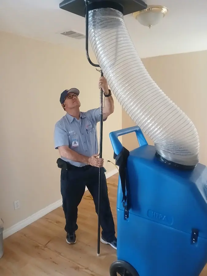 Furnace Tune-Up technician using HEPA equipment in Demarest